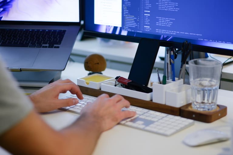 A person writing code at their computer