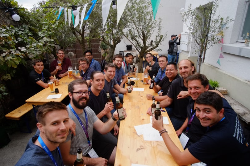 Swiss Drupal community members cheering at a restaurant