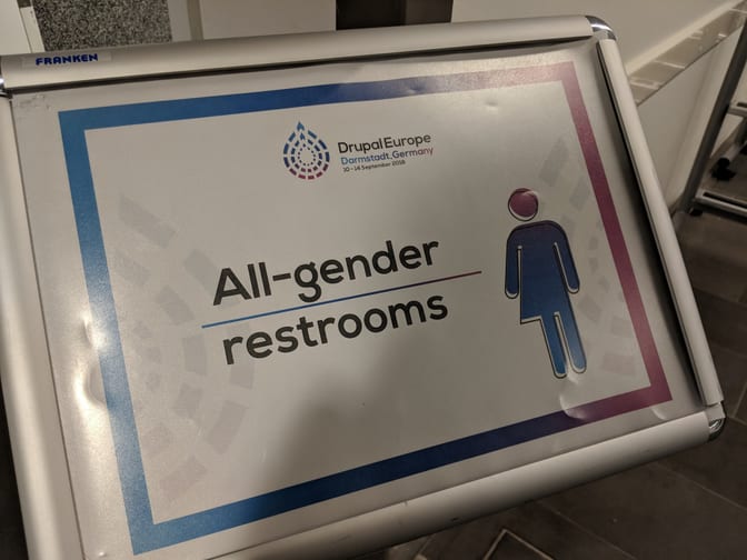 Sign mentionning "All-gender restrooms" at Drupal Europe venue.