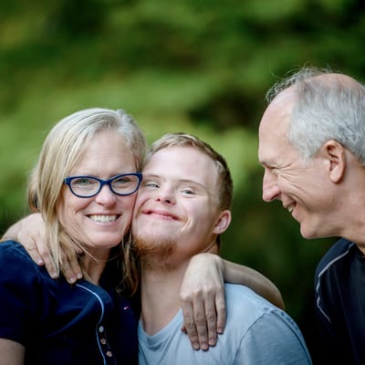 Man with Down syndrome and happy parents